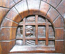 3091-detail of figure looking into prison on breton cabinet