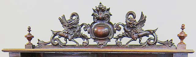 5183b-griffin ornamentation atop antique cabinet