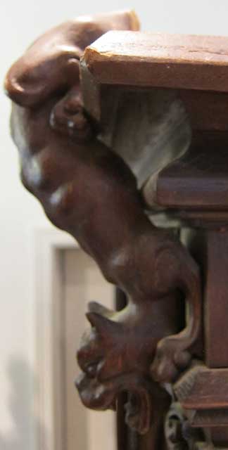 5193-dog crouching on antique armoire