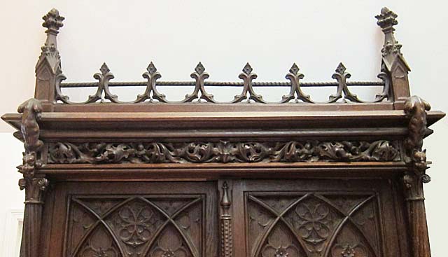 5193-gothic fenestrage atop antique armoire