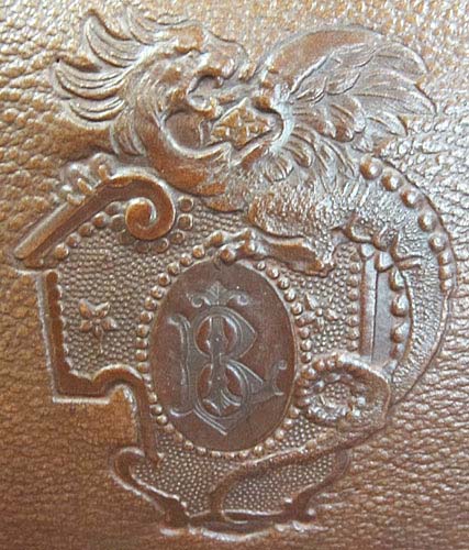 4124-detail of coat-of-arms on leather dining chair
