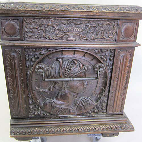 female medallion on antique chest